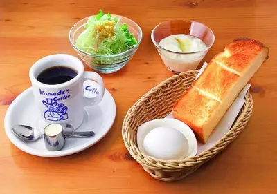 a table with a plate of bread and a cup of coffee at APA Hotel Asakusa Tawaramachi Ekimae in Tokyo