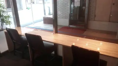 a wooden table with chairs in a room at Hotel Suntargas Otsuka in Tokyo