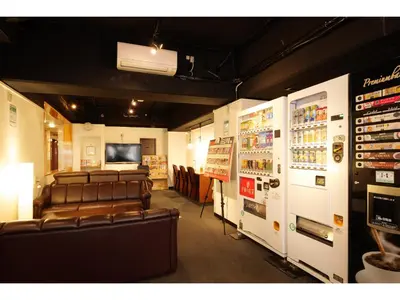 a room with leather chairs and a room with machines at Hotel Suntargas Otsuka in Tokyo