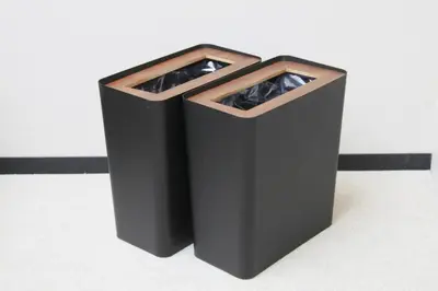 a black trash can sitting on the floor at Center Hotel Tokyo in Tokyo