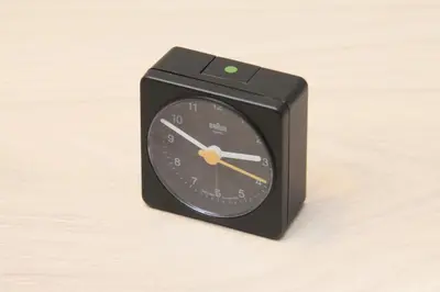 a black clock sitting on top of a table at Center Hotel Tokyo in Tokyo