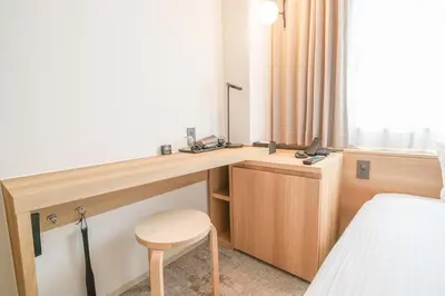 a hotel room with a desk and a bed at Center Hotel Tokyo in Tokyo