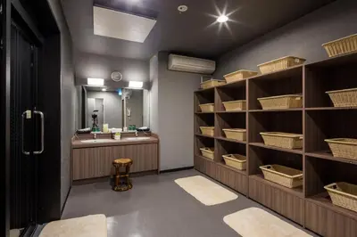 a bathroom with a sink and a counter with shelves at Hotel Route-Inn Tokyo Kamata -Ayamebashi- in Tokyo