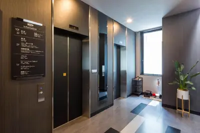 a hallway with a sign on the wall in a building at Hotel Route-Inn Tokyo Kamata -Ayamebashi- in Tokyo