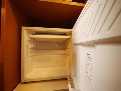 an empty refrigerator with its door open in a kitchen at Hotel Route-Inn Tokyo Kamata -Ayamebashi- in Tokyo