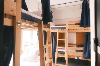 a room with two bunk beds and a ladder at Little Japan in Tokyo