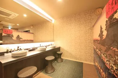 a bathroom with two sinks and two stools at Centurion Hotel&Spa Ueno Station in Tokyo