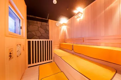 a sauna with yellow benches and a window at Centurion Hotel&Spa Ueno Station in Tokyo