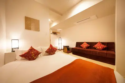 a bedroom with a large bed and a couch at Centurion Hotel&Spa Ueno Station in Tokyo