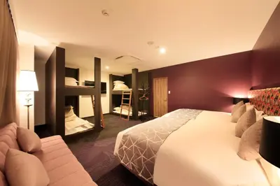 a hotel room with a bed and two bunk beds at Centurion Hotel&Spa Ueno Station in Tokyo