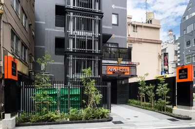 a black building with a sign on the side of it at APA Hotel Akihabaraeki-Denkigaiguchi in Tokyo