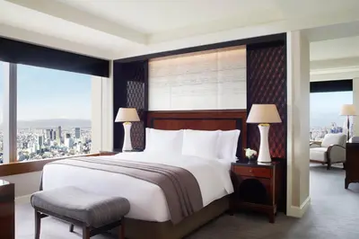 a bedroom with a large bed and a large window at The Ritz-Carlton, Tokyo in Tokyo