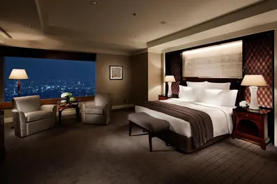 a hotel room with a bed and a large window at The Ritz-Carlton, Tokyo in Tokyo