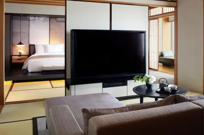 a living room with a large television and a bed at The Ritz-Carlton, Tokyo in Tokyo
