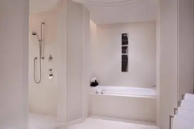 a white bathroom with a shower and a tub at The Ritz-Carlton, Tokyo in Tokyo