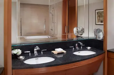 a bathroom with two sinks and a bath tub at The Ritz-Carlton, Tokyo in Tokyo