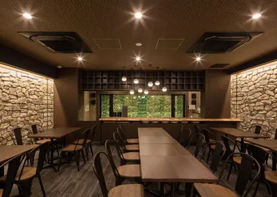 a restaurant with tables and chairs and a window at Hotel SUI Ginza Kyobashi by ABEST in Tokyo