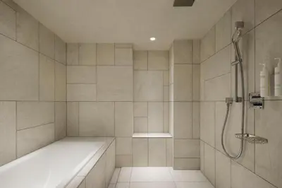 a bathroom with a shower and a bath tub at Courtyard by Marriott Tokyo Ginza Hotel in Tokyo