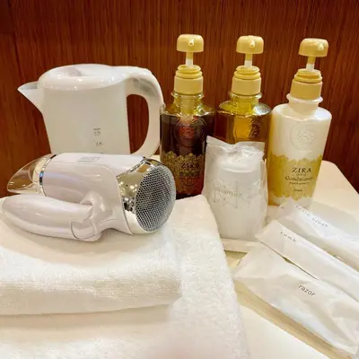 a table topped with bottles of soap and towels at Sakura Hotel Ikebukuro in Tokyo
