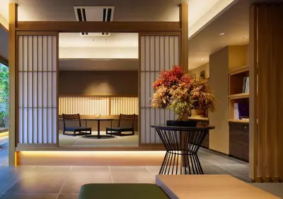 a lobby with a table with a vase of flowers at Hotel Niwa Tokyo in Tokyo