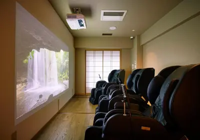a waiting room with black chairs and a large window at Hotel Niwa Tokyo in Tokyo