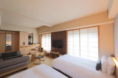 a hotel room with two beds and a television at Hotel Niwa Tokyo in Tokyo