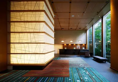 an office lobby with a large wall of windows at Hotel Niwa Tokyo in Tokyo