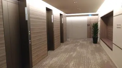 a hallway with wooden walls and a potted plant at Nihon Seinenkan Hotel in Tokyo