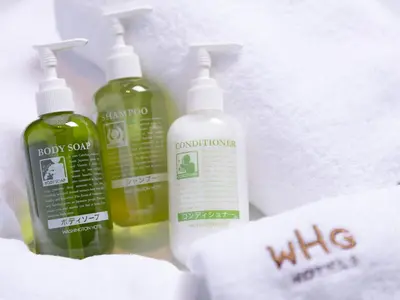 three bottles of cleaning products in a white bag at Hotel Gracery Ginza in Tokyo