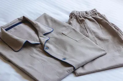 a shirt and pants laying on a bed at Hotel Gracery Ginza in Tokyo