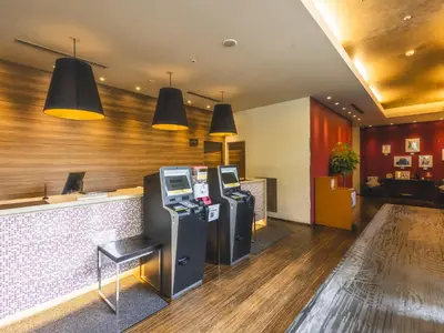 a restaurant with two atm machines in a lobby at Hotel Gracery Tokyo Tamachi in Tokyo