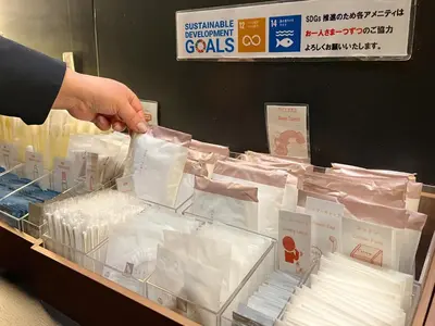 a person is reaching for a display in a store at Hotel Gracery Tokyo Tamachi in Tokyo