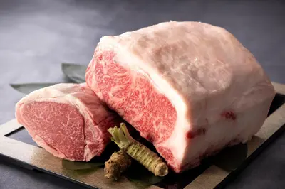 two pieces of meat on a plate on a table at Shinjuku Washington Hotel in Tokyo