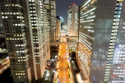 a city street at night with tall buildings at Shinjuku Washington Hotel in Tokyo