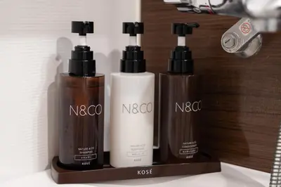 a group of three bottles ofodorizers sitting on a shelf at Hotel Rose Garden Shinjuku in Tokyo