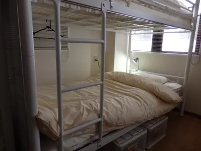 a bed in a room with a bunk bed at Backpacker's Mini House in Tokyo