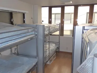 a group of bunk beds in a room at Backpacker's Mini House in Tokyo