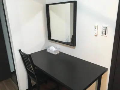 a black table with a mirror and a chair at TIMES INN 2F in Tokyo