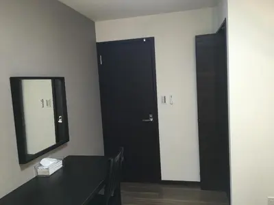 a black door in a room with a table and a mirror at TIMES INN 2F in Tokyo