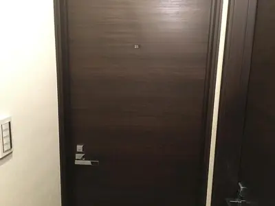 a black door with a handle in a room at TIMES INN 2F in Tokyo