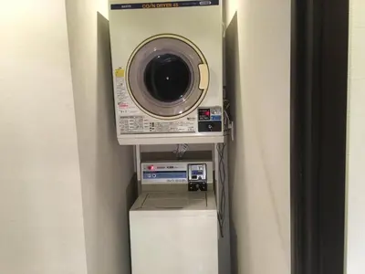 a washing machine sitting on top of a refrigerator at TIMES INN 2F in Tokyo