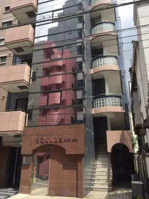 a reflection of a building in the windows of a street at TIMES INN 2F in Tokyo