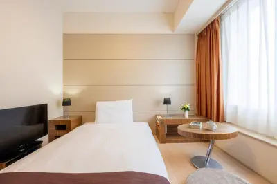 a hotel room with a bed and a tv at Tokyo Bay Ariake Washington Hotel in Tokyo