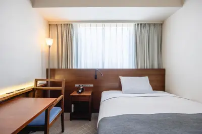 a bedroom with a bed and a table and a desk at Tokyo Bay Ariake Washington Hotel in Tokyo