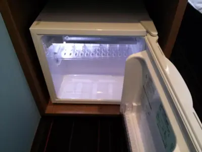an empty refrigerator with its door open on a shelf at the b shimbashi in Tokyo