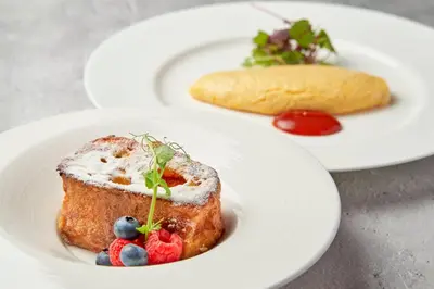 a plate of food with a piece of bread and fruit at Shibuya Tokyu REI Hotel in Tokyo