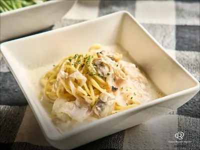 a white bowl of pasta with meat and cheese at Daiwa Roynet Hotel Tokyo Osaki in Tokyo