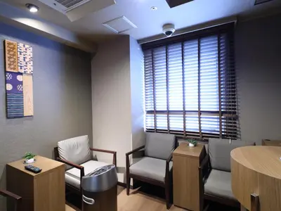 a waiting room with two chairs and a window at Dormy Inn Tokyo Hatchobori - Natural Hot Spring in Tokyo
