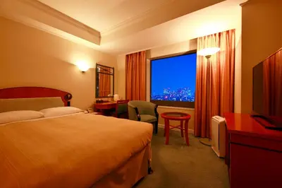 a hotel room with a bed and a large window at Hotel East 21 Tokyo in Tokyo