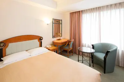 a hotel room with a bed and a table and a chair at Hotel East 21 Tokyo in Tokyo